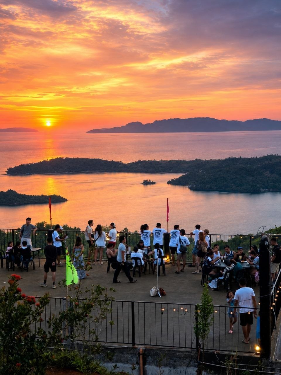A full terrace of guests watching the sunset over Dinagat Islands from Laaganan Skybar.